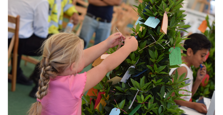 picture of girl adding to the pledge tree